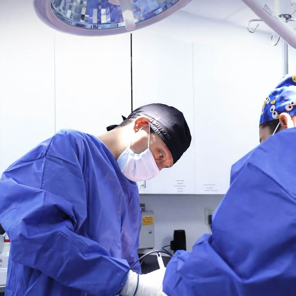 Millennial Plastic Surgery Surgeon Operating With Team